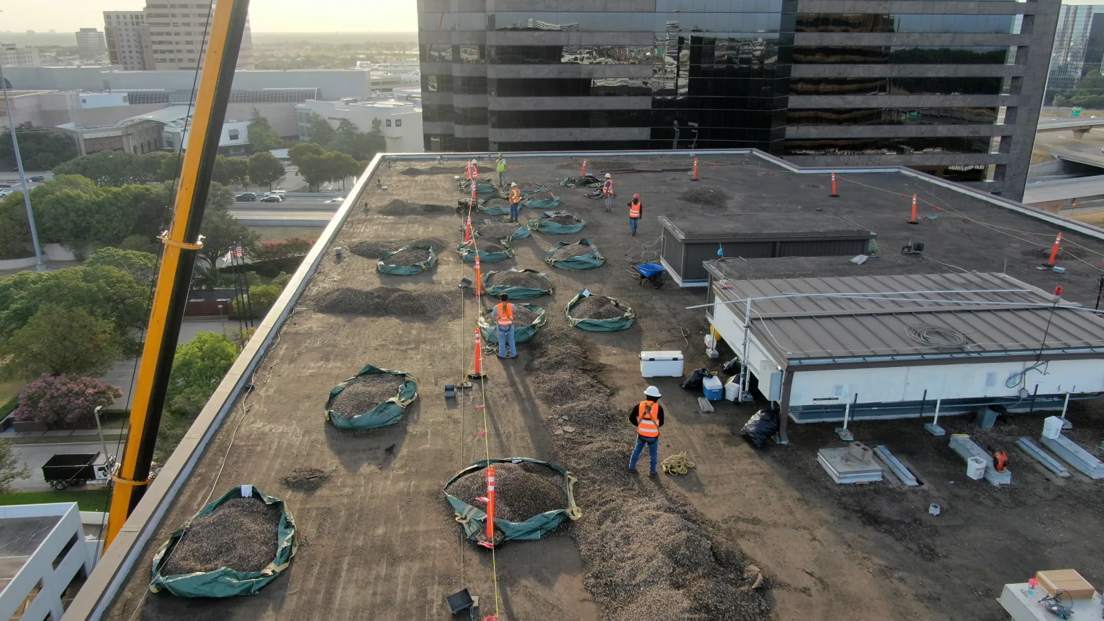 Crew working with roofing materials on a Dallas commercial rooftop